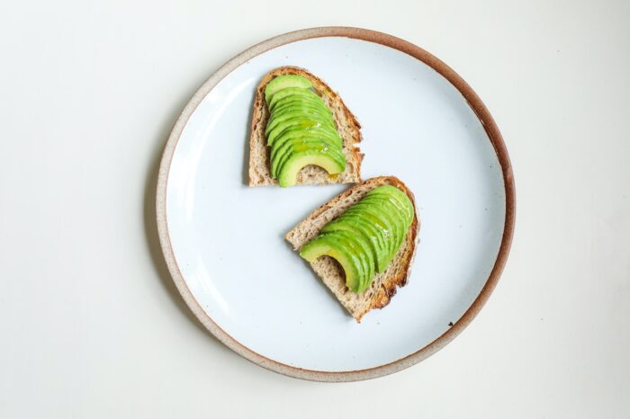 Birds eye view of avocado toast on a white plate.